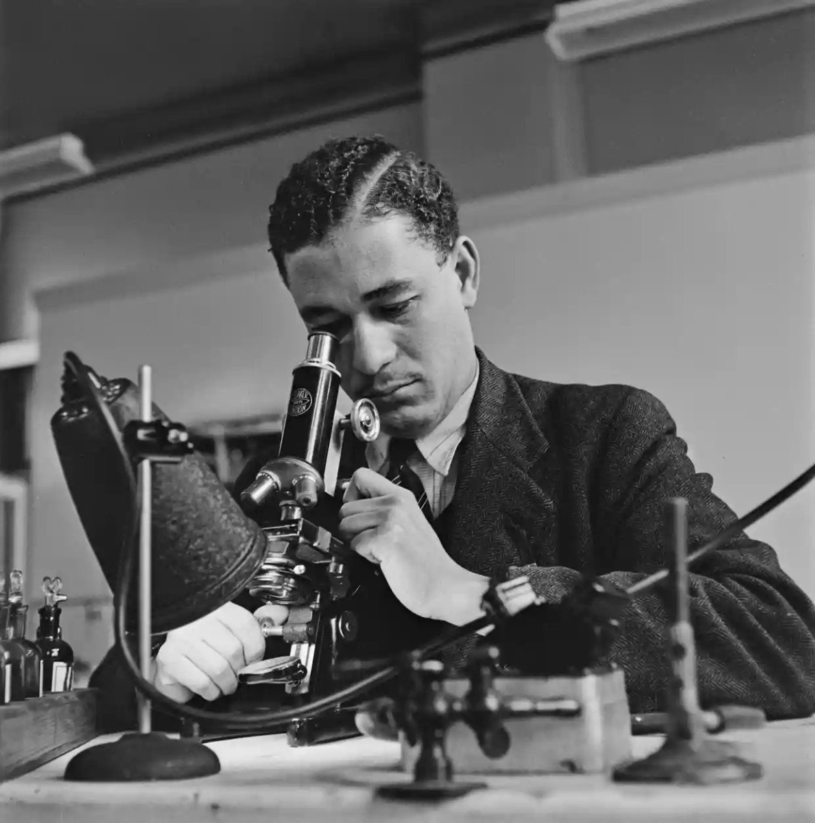 A scientist photographed in London in 1948 with microscope